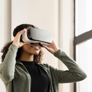 An African American Woman using a Virtual Reality headset, also known as a VR Headset